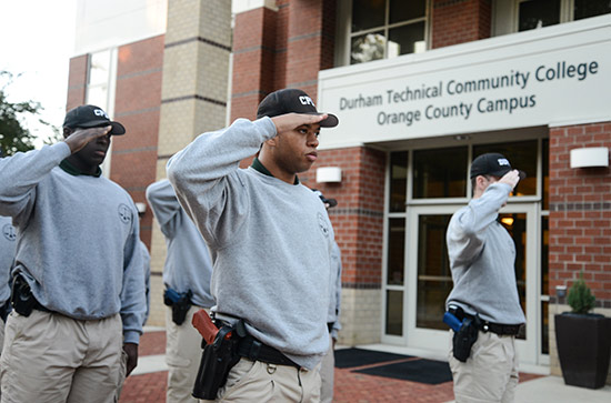 Basic Law Enforcement training students saluting in front of the Orange County Campus